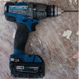 Close-up of a professional Makita cordless power drill on a work surface; a tool used by the Valerio Plumbing team for precision installations and repairs.