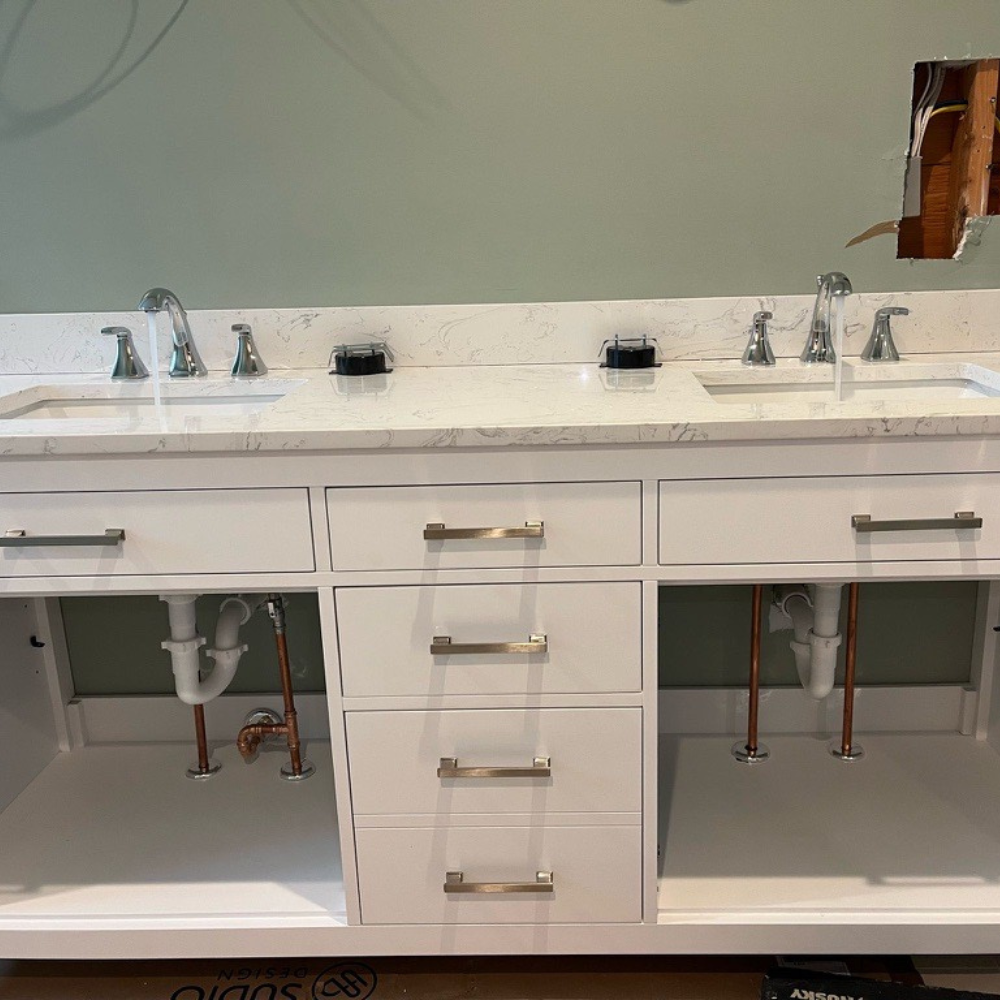 Modern double vanity sinks with running water to verify leak-free plumbing installation