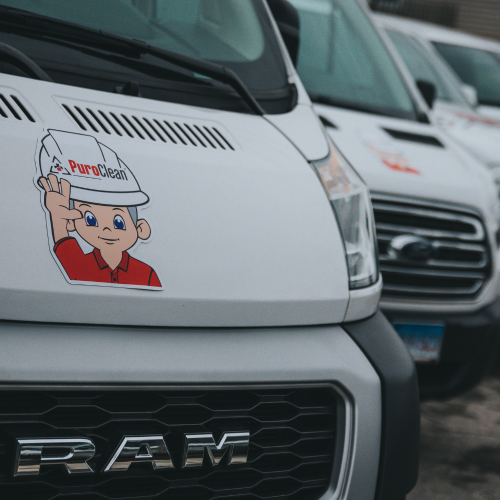 Fleet of white Valerio Plumbing service vans parked and ready for emergency dispatch.